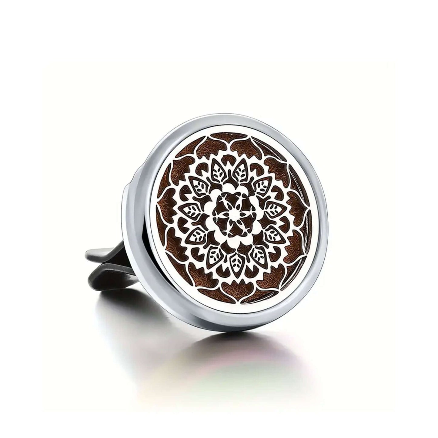 Round metal car air freshener disc with intricate design on a white background