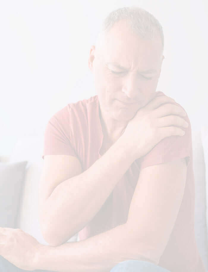 Man holding sore shoulder