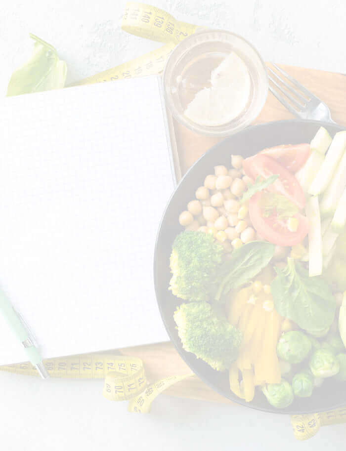 A bowl of salad next to a food diary