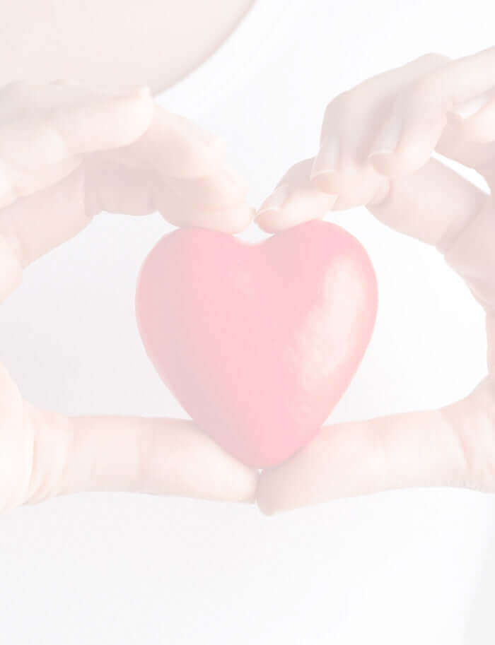 hands holding a red glass heart