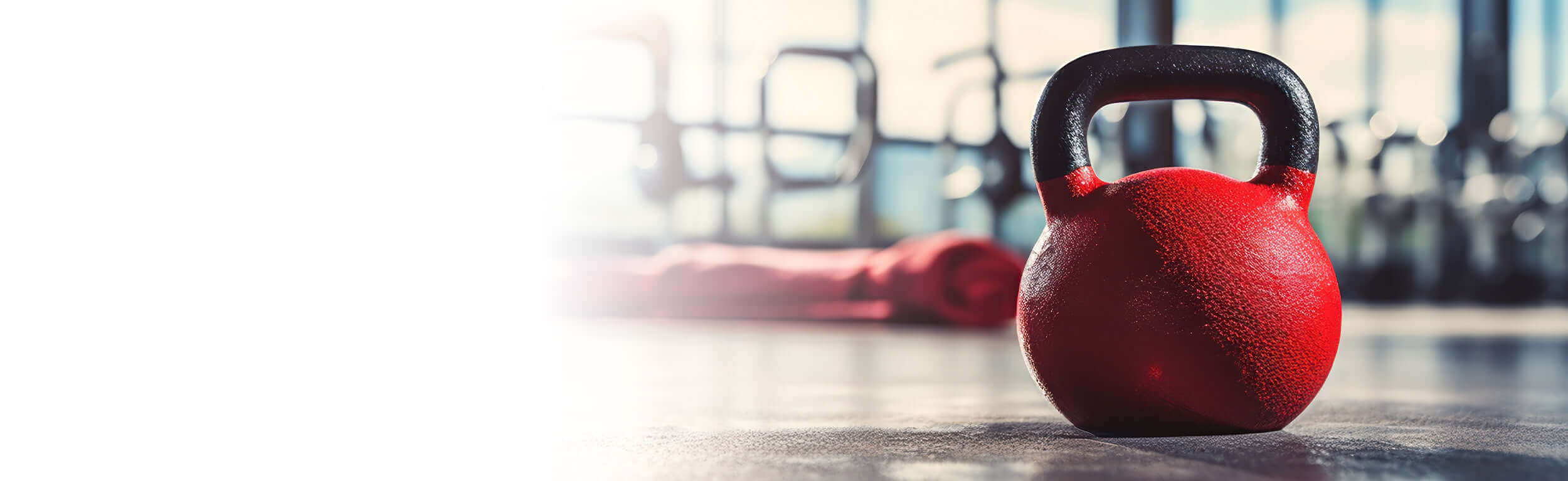 A red dumbbell on a gym floor