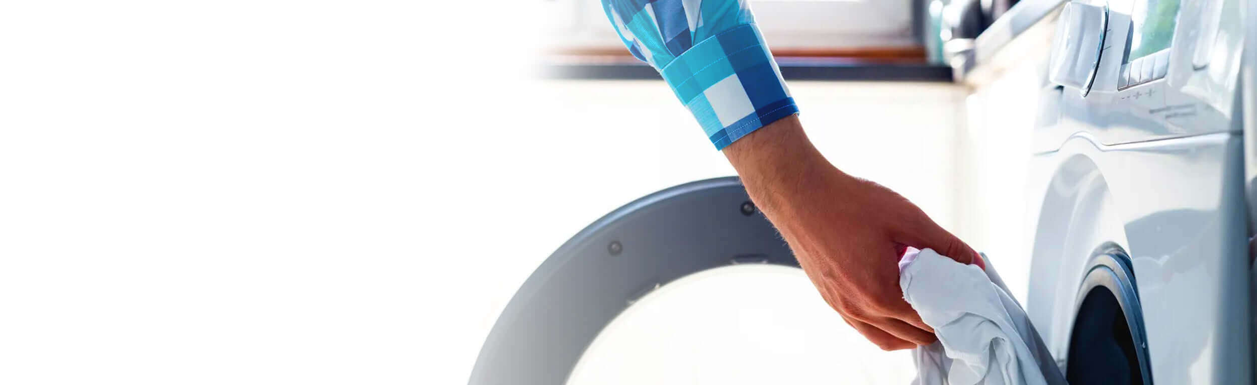 A man loading the washing machine