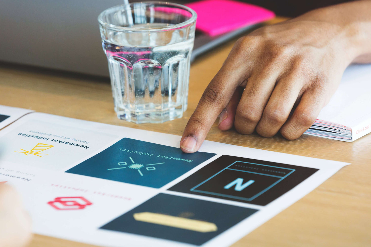 A woman choosing a design from a variety of print outs