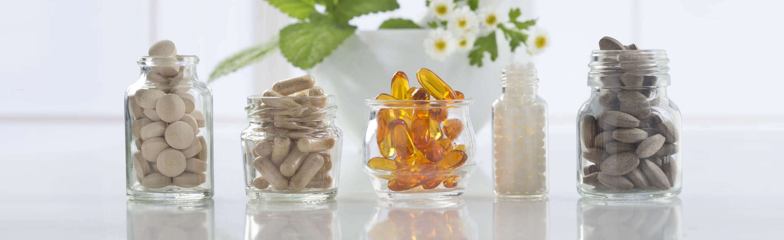 A variety of capsules and tablets in glass bottles
