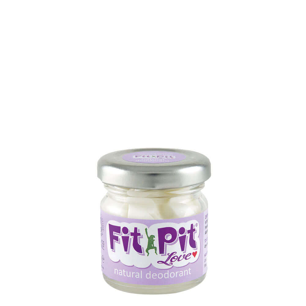 A small clear glass jar with a silver lid labeled 'Fit Pit Love natural deodorant', indicating that it is an organic and vegan-friendly product.