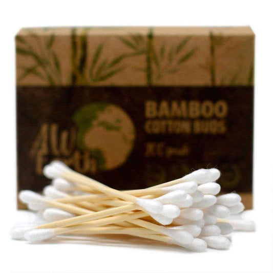 Biodegradable bamboo cotton buds in front of eco-friendly packaging