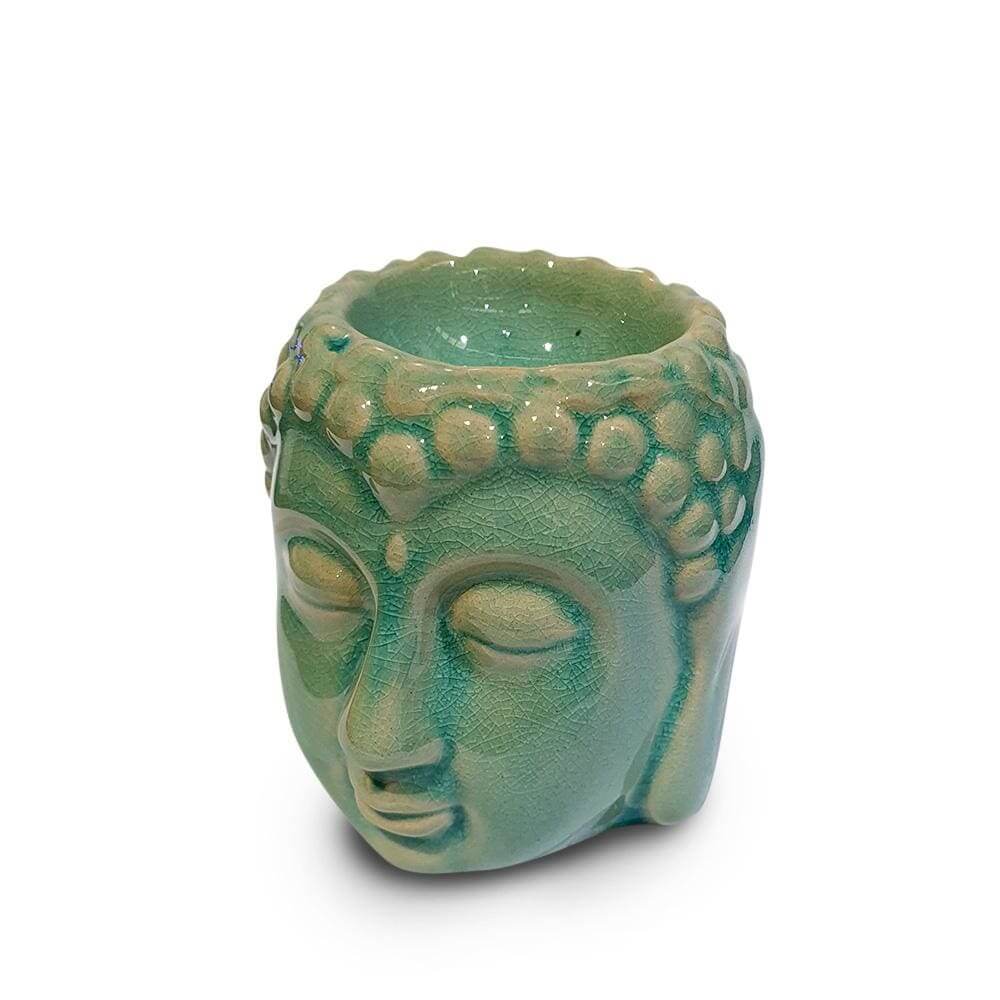 Blue ceramic Buddha head oil burner with textured surface and hollow top for holding essential oils or wax melts.