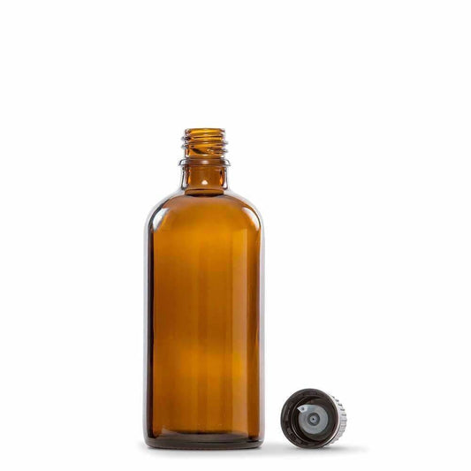 100ml amber glass bottle with black screw cap removed, placed beside the bottle