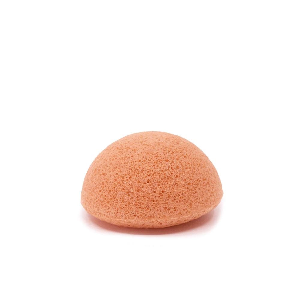 Pink konjac facial sponge with porous texture, rounded shape, on white background for gentle skin cleansing and exfoliation.