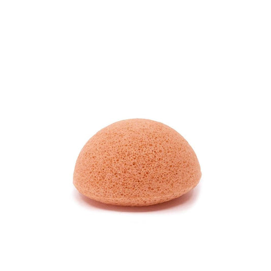 Pink konjac facial sponge with porous texture, rounded shape, on white background for gentle skin cleansing and exfoliation.