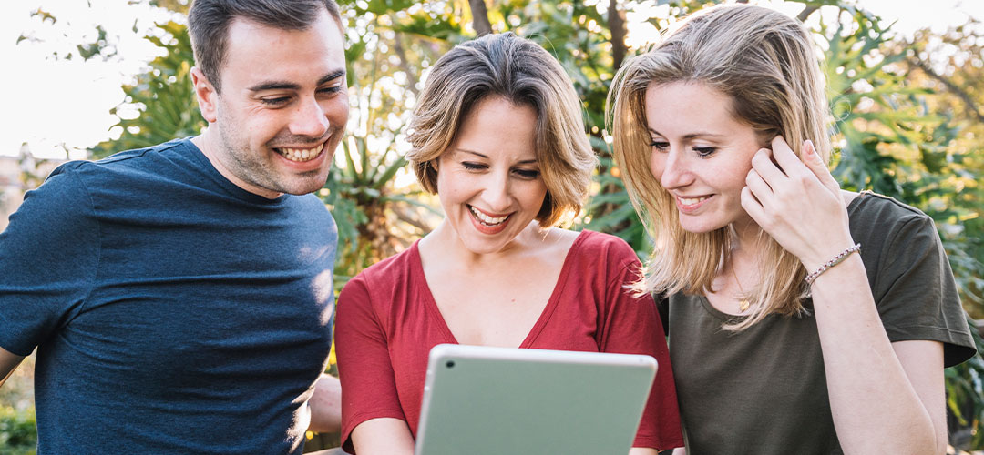 friends looking at a tablet and enjoying the content