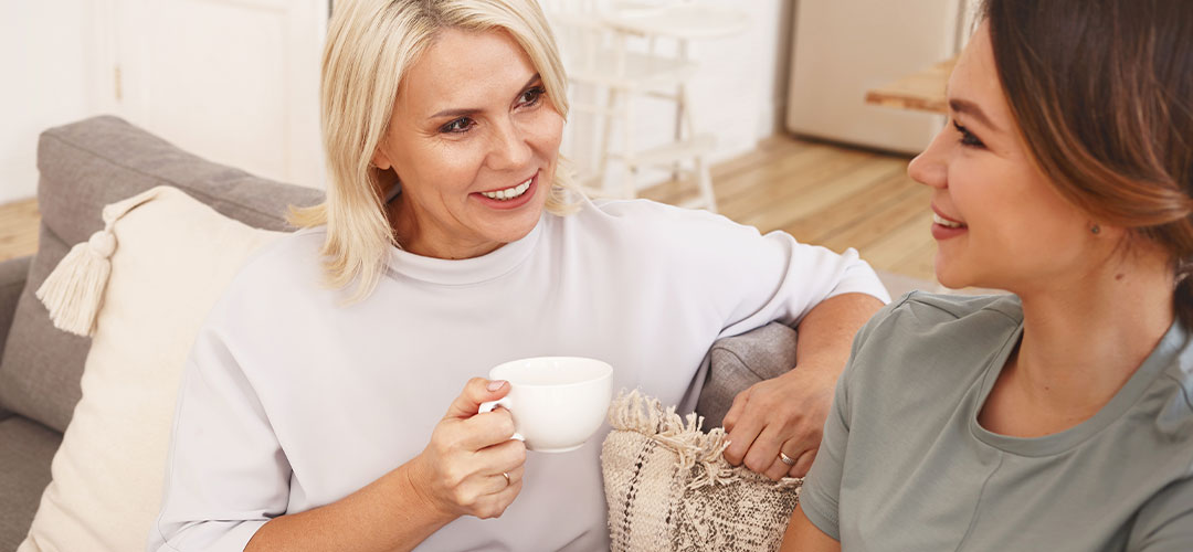 two ladies chatting on the couch supporting each other
