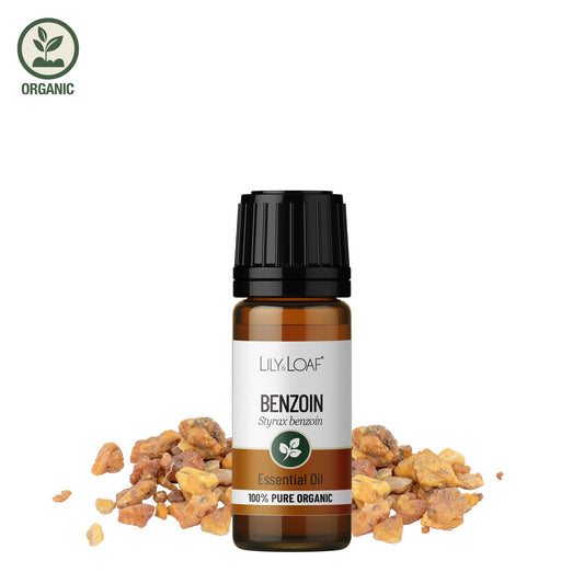 Benzoin essential oil bottle with resin on a white background