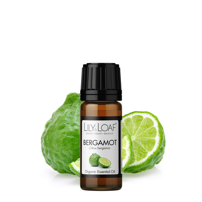 Lily & Loaf Organic Bergamot Essential Oil bottle in front of a bergamot