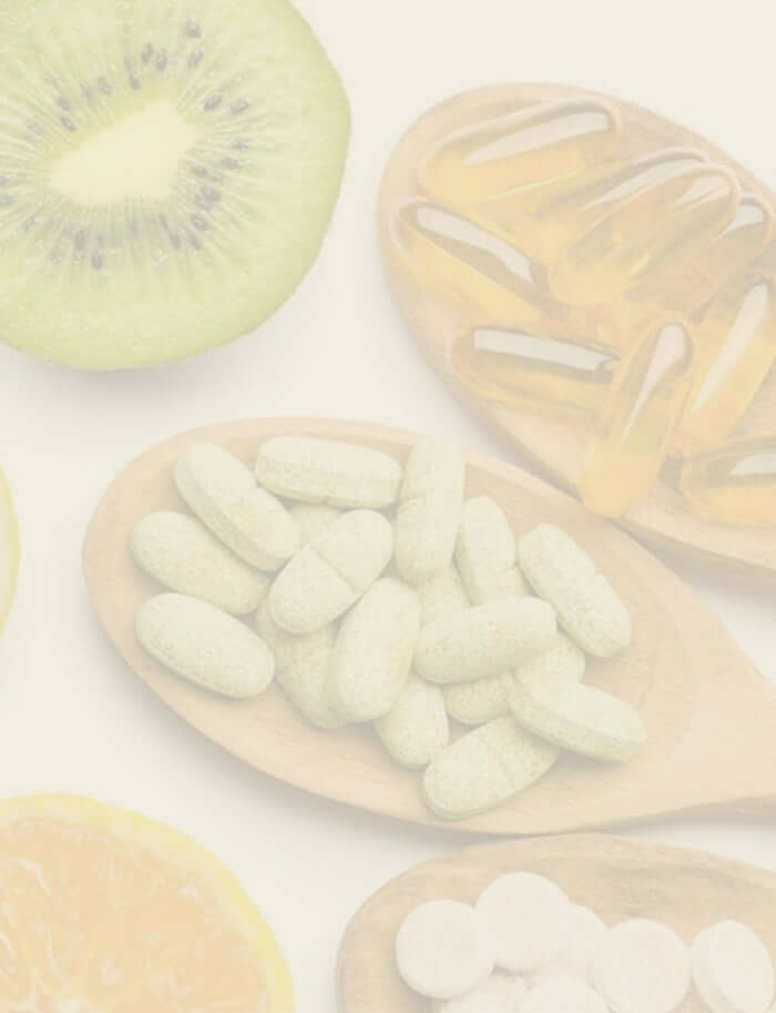 supplements in wooden spoons and fruits laid out on a table